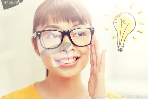 Image of asian woman in glasses with light bulb doodle