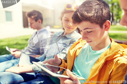 Image of happy friends or students with tablet pc outdoors