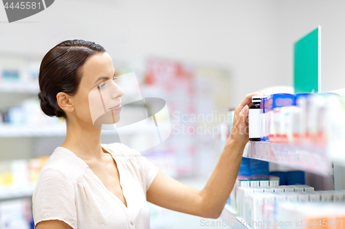 Image of female customer choosing drugs at pharmacy