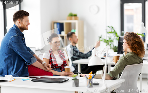 Image of creative team drinking coffee at office