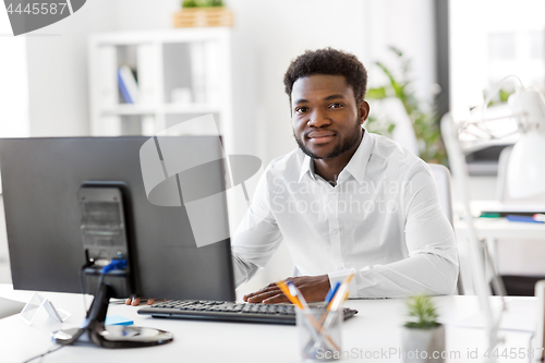 Image of african businessman with computer at office