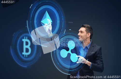 Image of businessman with cryptocurrency holograms