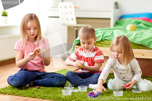 Image of kids with modelling clay or slimes at home