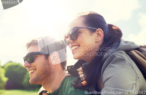 Image of happy couple with backpacks having fun outdoors