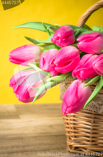 Image of Beautiful bouquet of pink tulips in a wicker basket