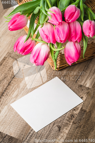 Image of Beautiful bouquet of pink tulips and congratulations on the table