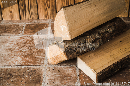 Image of Logs of firewood on the floor, close-up