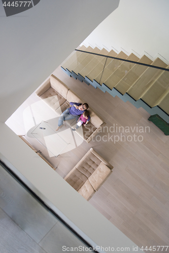 Image of mother and her cute little daughter are using a tablet top view