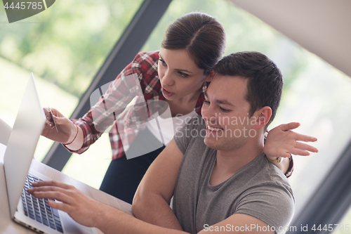 Image of happy young couple buying online