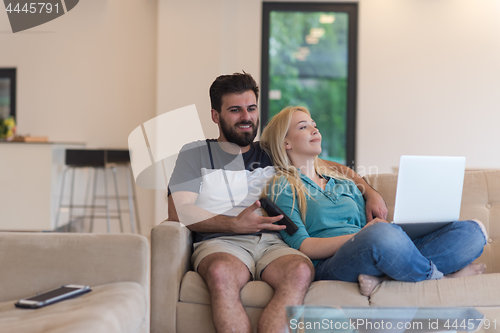 Image of young happy couple relaxes in the living room