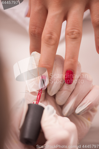 Image of Woman hands receiving a manicure