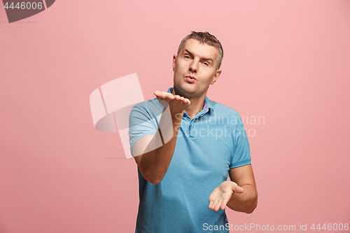 Image of Portrait of attractive man with kiss isolated over pink background