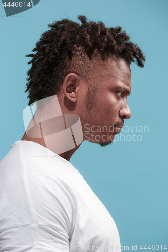 Image of The young emotional angry afro man on blue studio background