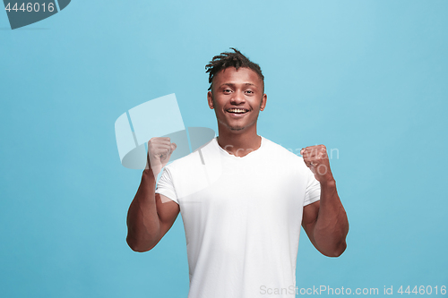 Image of Winning success afro-american man happy ecstatic celebrating being a winner. Dynamic energetic image of male model