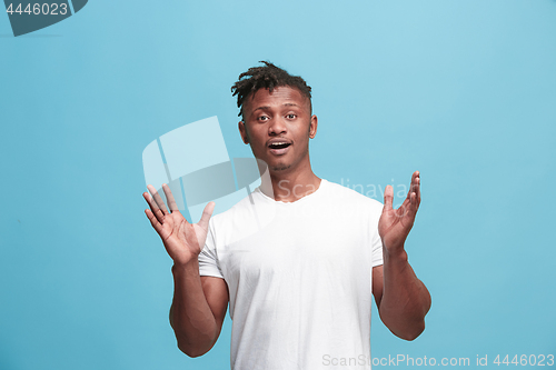 Image of Handsome afro-american man looking suprised isolated on blue