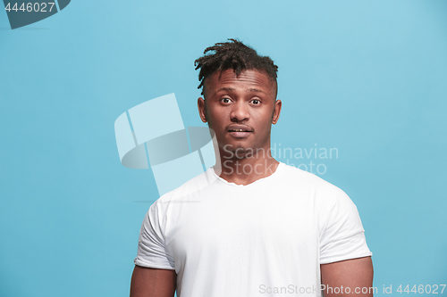 Image of The surprised business Afro-American man standing and looking pink background.