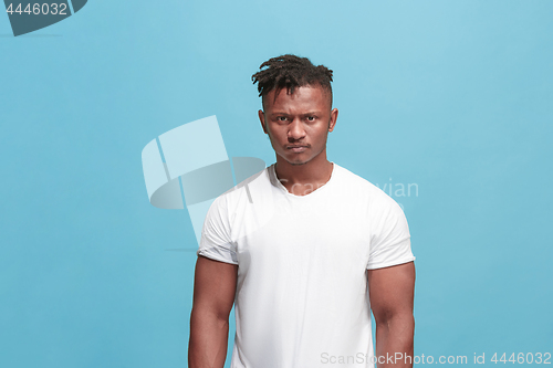 Image of The young emotional angry afro man on blue studio background