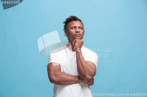 Image of Young serious thoughtful Afro-American businessman. Doubt concept.