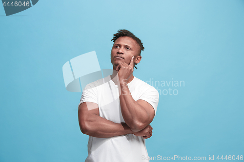 Image of Young serious thoughtful Afro-American businessman. Doubt concept.