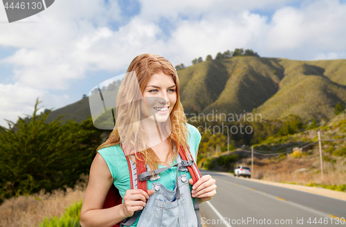 Image of smiling woman with backpack over big sur hills