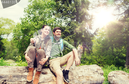 Image of smiling couple with backpacks in nature