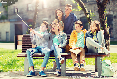 Image of happy teenage students taking selfie by smartphone