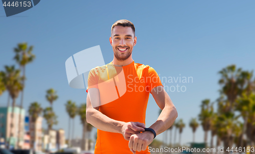 Image of man with fitness tracker training outdoors