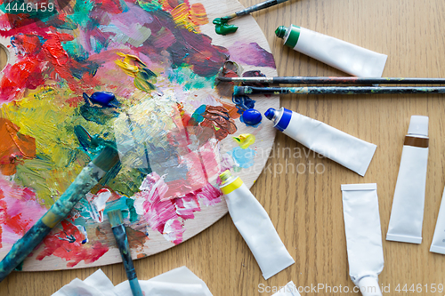 Image of palette, brushes and paint tubes on table