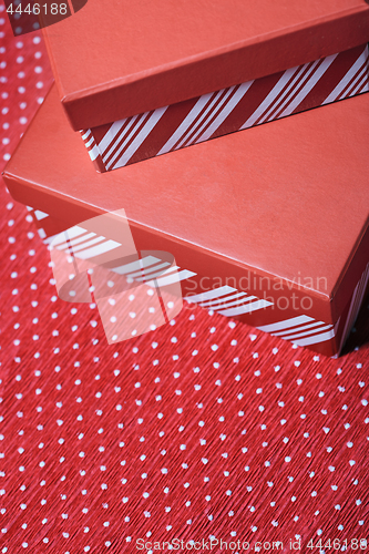 Image of Christmas gift boxes on a red wrapping paper