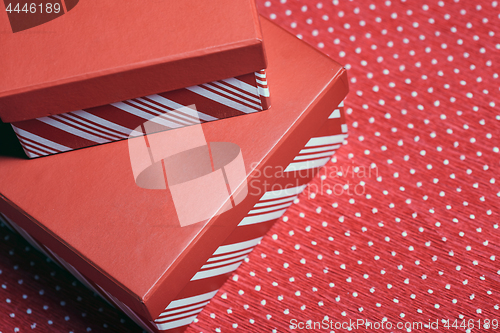 Image of Christmas gift boxes on a red wrapping paper