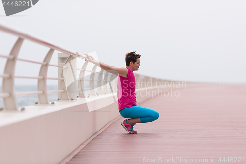 Image of woman stretching and warming up on the promenade