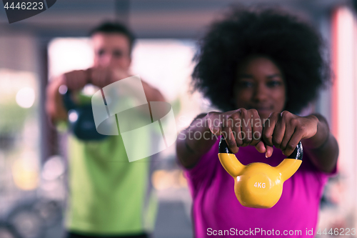Image of couple  workout with weights at  crossfit gym