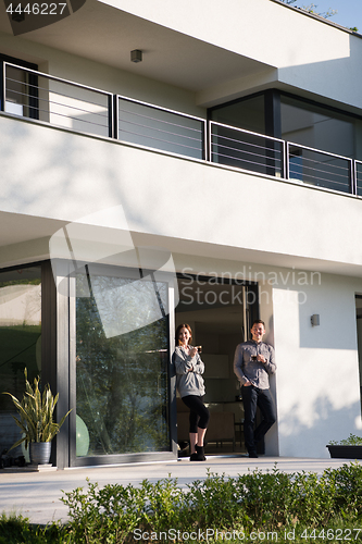 Image of couple enjoying on the door of their luxury home villa