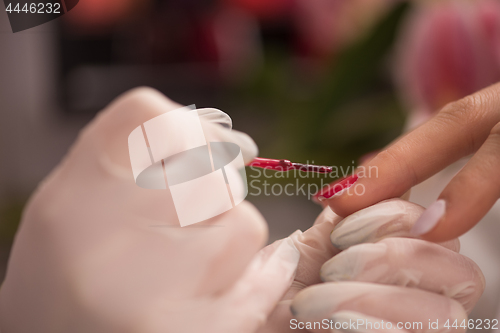 Image of Woman hands receiving a manicure