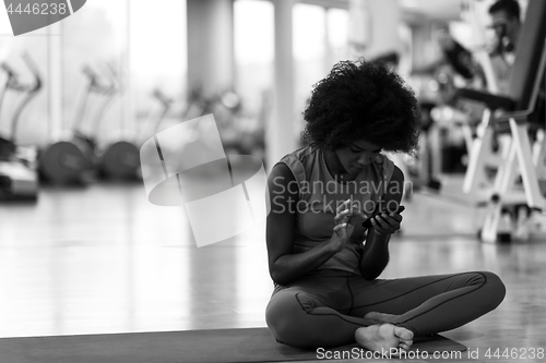 Image of african american woman exercise yoga in gym