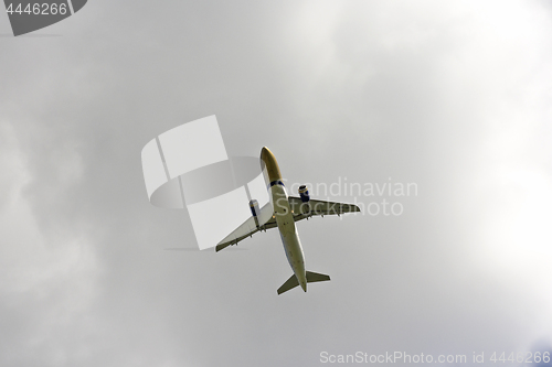 Image of Airplane flies against a background of white cloud