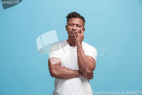 Image of Young serious thoughtful Afro-American businessman. Doubt concept.