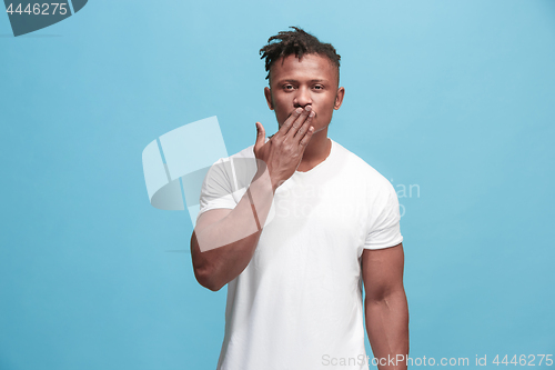 Image of Portrait of attractive Afro-American man with air kiss isolated over blue background