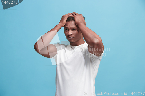 Image of African American Man having headache. Isolated over blue background.