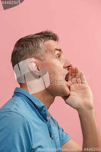 Image of Isolated on pink young casual man shouting at studio