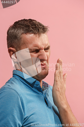 Image of Let me think. Doubtful pensive man with thoughtful expression making choice against pink background