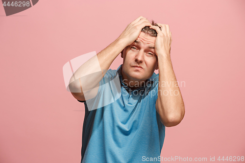 Image of Handsome man in stress isolated on pink