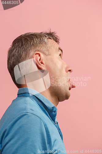Image of The squint eyed man with weird expression isolated on pink