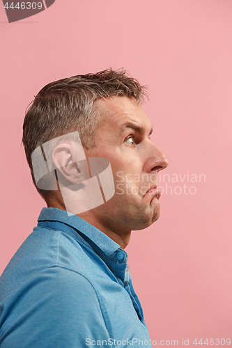 Image of Beautiful man looking suprised and bewildered isolated on pink