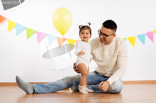 Image of happy father and little daughter at birthday party
