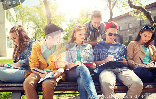 Image of group of students with notebooks at school yard