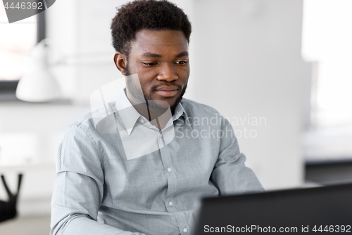Image of african american businessman with laptop at office