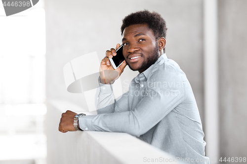 Image of businessman calling on smartphone at office