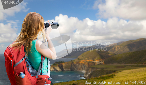 Image of woman with backpack and camera at big sur coast