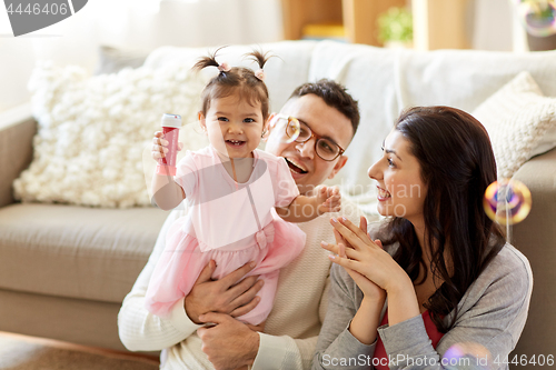 Image of family with soap bubbles playing at home